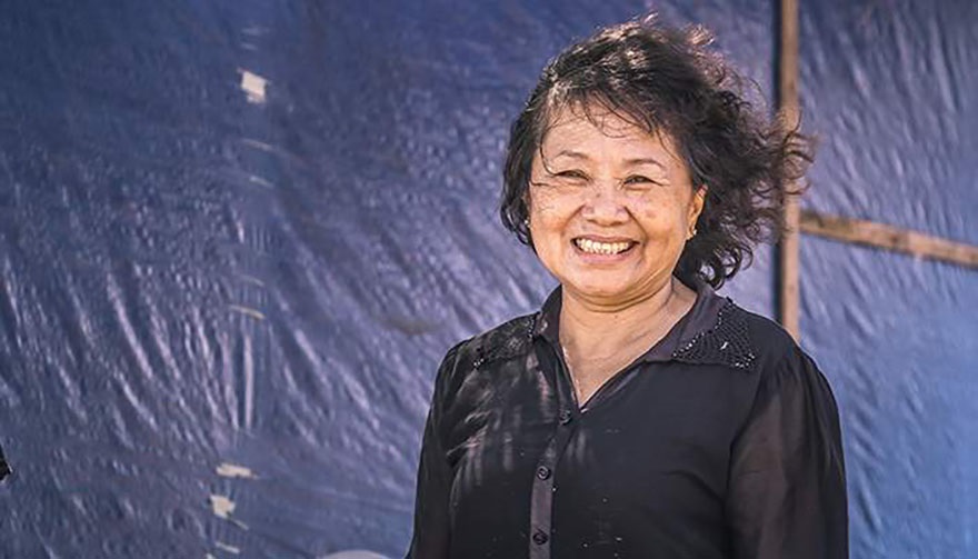 Portrait shot of woman (Mrs Nga) in black shirt with hair blowing in the wind